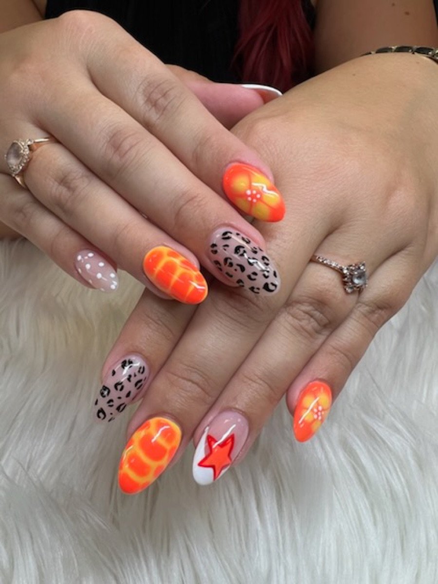 Orange and leopard print nail set done at Color Nails Club